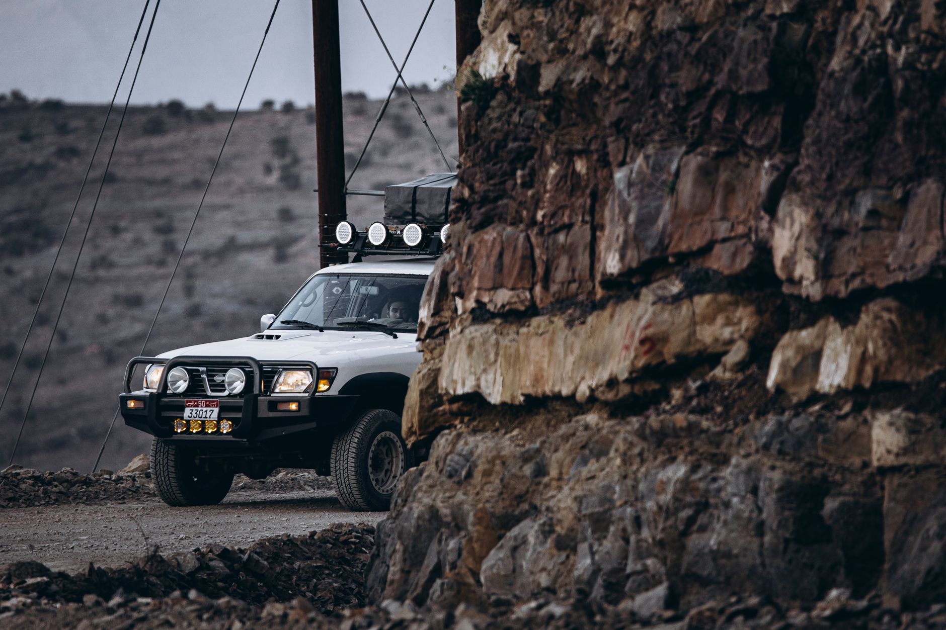 A 4x4 on a desert track under the Oman sky